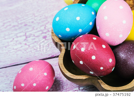 different color Easter eggs on a wooden table different color Easter eggs on a wooden table 37475192
