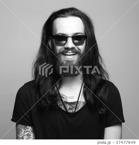 happy smiling hipster. tattoo and sunglasses 37477649