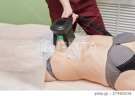 Woman getting cryolipolysis fat treatment Woman getting cryolipolysis fat treatment 37480836