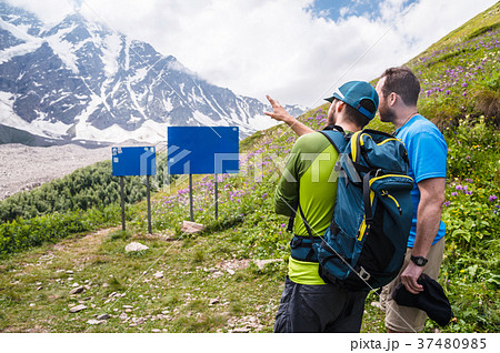 Mock up. Two tourists with backpacks stand in the 37480985