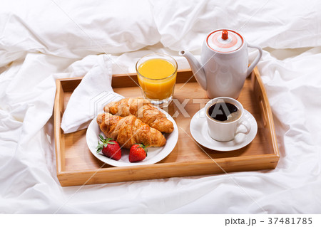breakfast tray with coffee and croissants in bed breakfast tray with coffee and croissants in bed 37481785