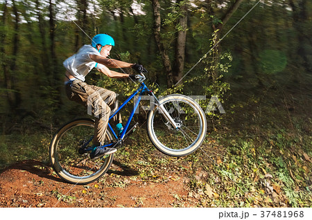 a young guy in a helmet flies landed on a bicycle a young guy in a helmet flies landed on a bicycle 37481968