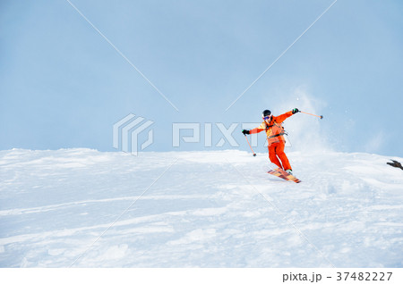 Ski athlete in a fresh snow powder rushes down the 37482227