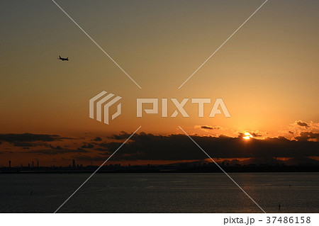 日本の都市景観「舞浜から見る東京湾と飛行機、沈む太陽」（画面左奥付近には横浜のＭＭ２１が見える） 37486158