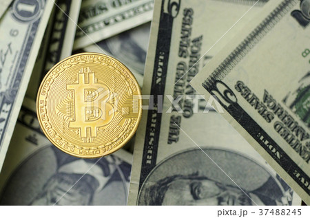 Bit coin with a dollar banknote background. 37488245