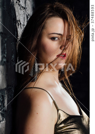 close-up portrait plus size model in a gold blouse 37488593