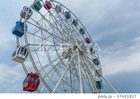 Colorful Ferris wheel against blue sky Colorful Ferris wheel against blue sky 37491837