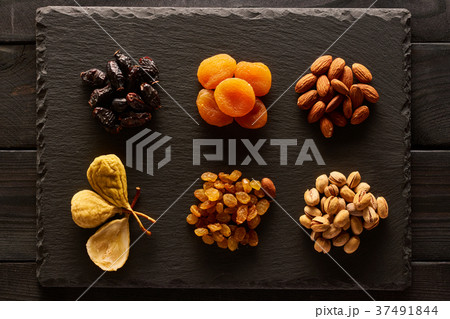 Dried fruits and nuts on slate plate 37491844