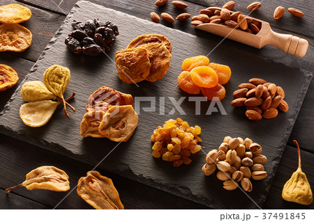 Dried fruits and nuts on slate plate 37491845