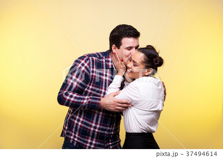Man kissing her wife on the cheek 37494614