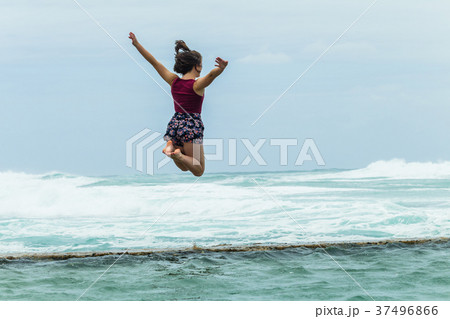 Girl Jumping Leap Beach Tidal Pool Ocean 37496866