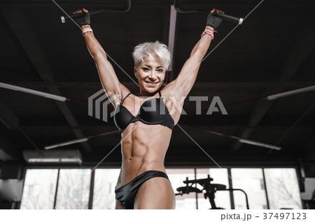 blonde sexy athletic young girl working out in gym.. 37497123