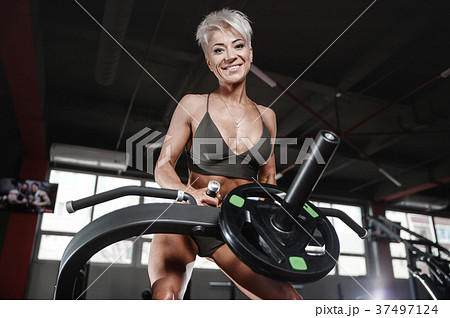 blonde sexy athletic young girl working out in gym.. blonde sexy athletic young girl working out in gym.. 37497124
