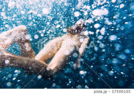Young naked woman dive in ocean, air bubbles Young naked woman dive in ocean, air bubbles 37500105