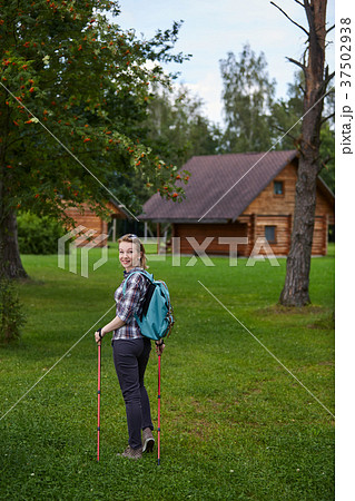young woman with nordic walk pols 37502938