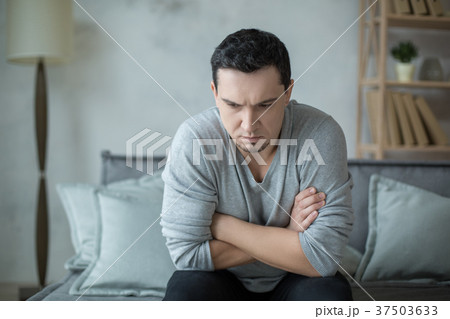 Man sitting upset psychology session mental health Man sitting upset psychology session mental health 37503633