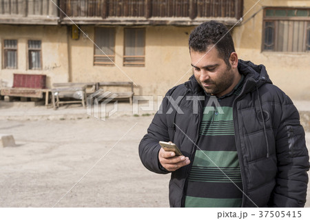 Handsome young man working with cellphone  37505415