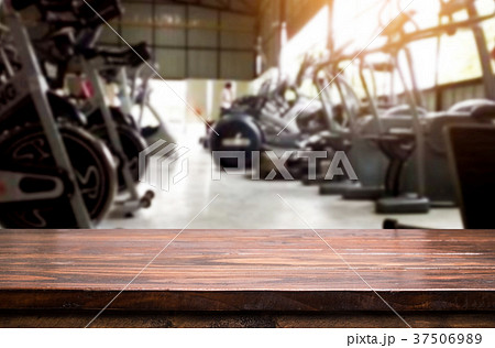 Wooden table on blurred background of fitness gym interior of mo 37506989