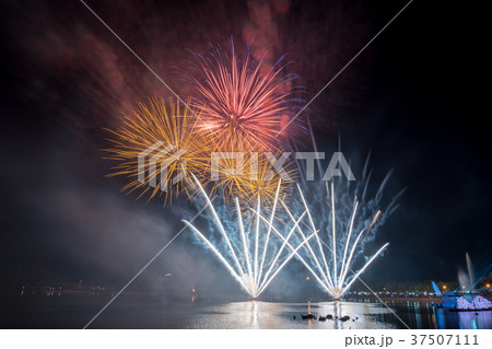Bright and colorful firework against a black night 37507111