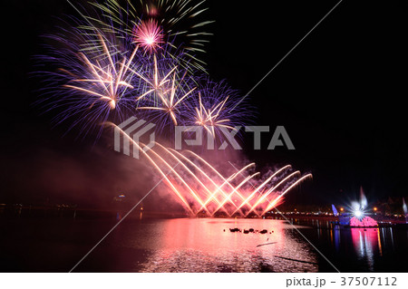 Bright and colorful firework against a black night 37507112