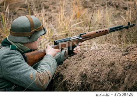 A German soldier with a Soviet rifle in the trench 37509426