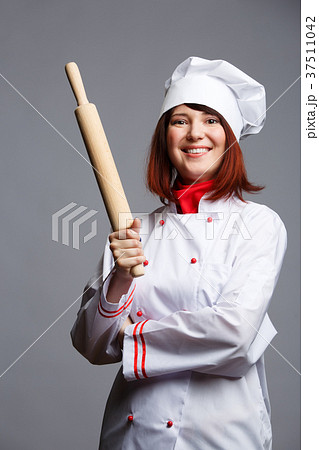 Picture of brunette chef in white robe and cap 37511042