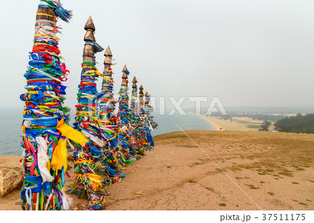 Wooden ritual pillars with colorful ribbons Hadak 37511175