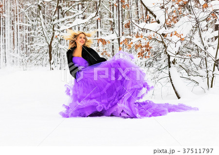 Young woman in a long dress in winter forest 37511797