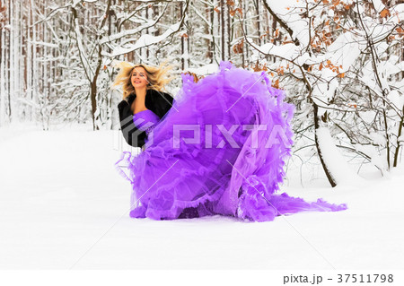 Young woman in a long dress in winter forest 37511798