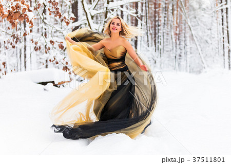 Young woman in a long dress in winter forest 37511801