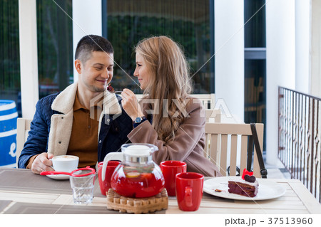 restaurant. a guy with a girl drink hot coffee and 37513960