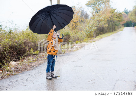 a little boy walks in the rain umbrella autumn 37514368