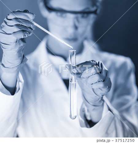 Young scientist pipetting in life science 37517250