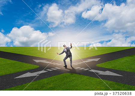 Young businessman at crossroads in uncertainty Young businessman at crossroads in uncertainty 37520638