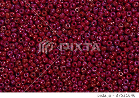 Seed beads of dark red color on the textile Seed beads of dark red color on the textile 37521646