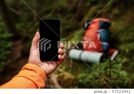 Hand of young man, which is standing on the rock 37522041