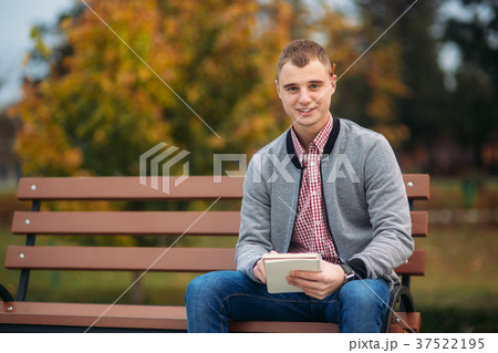 A cute student writes down his thoughts in his A cute student writes down his thoughts in his 37522195