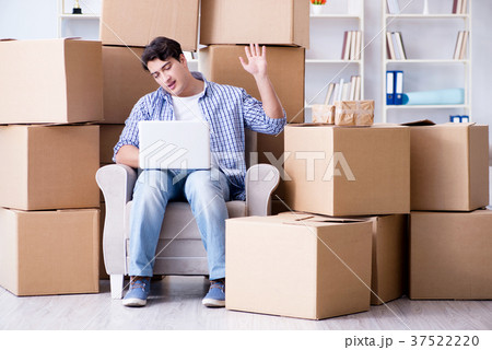 Young man moving in to new house with boxes 37522220