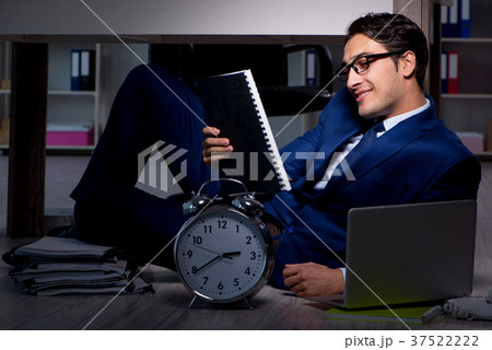 Businessman working overtime long hours late in Businessman working overtime long hours late in 37522222