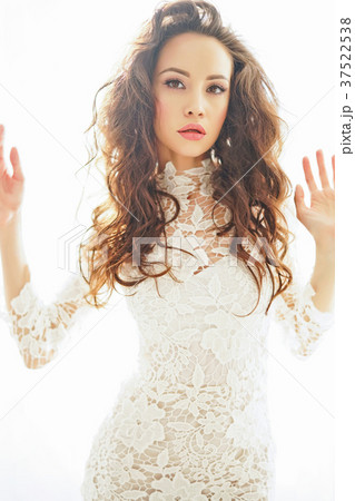 Beautiful woman in white dress 37522538