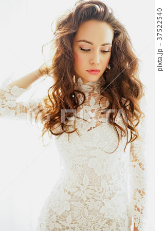 Beautiful woman in white dress 37522540