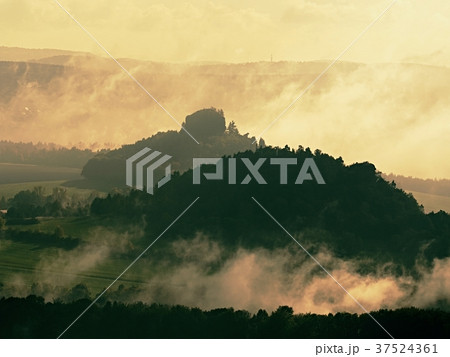 Morning mist and fog covering hilly landscape Morning mist and fog covering hilly landscape 37524361
