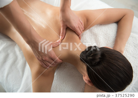 Beautician arms undergoing back massage treatment Beautician arms undergoing back massage treatment 37525290