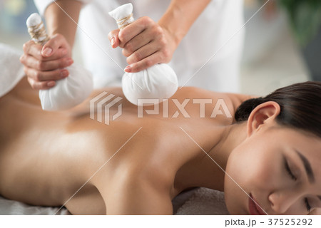 Skillful beautician doing massage with special Skillful beautician doing massage with special 37525292