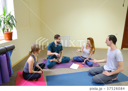 Two young women and two men sit on floor in Two young women and two men sit on floor in 37526084