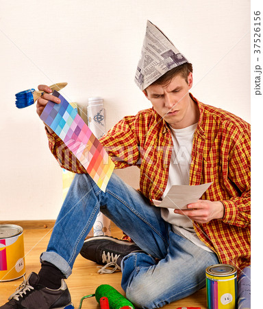 Repair home man holding paint roller for wallpaper Repair home man holding paint roller for wallpaper 37526156