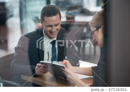 Outgoing colleagues watching at appointment book 37526301