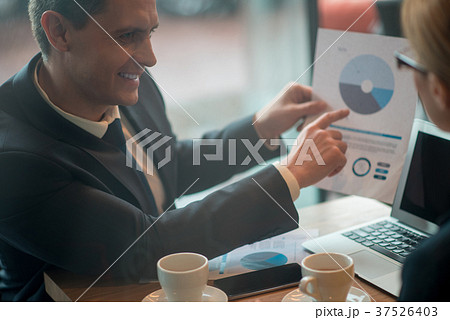 Happy businessman demonstrating information to 37526403