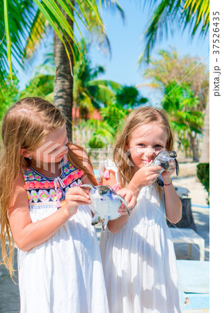 Adorable little girls with small turtles in hands 37526435