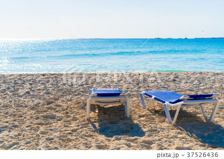 Beach sunbeds on white sand in soft evening light Beach sunbeds on white sand in soft evening light 37526436